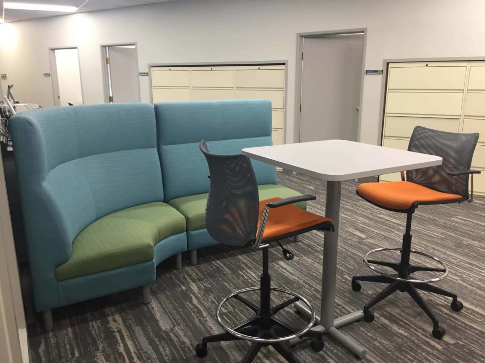 Collaborative work space with high back seating area, high-top table and tall swivel chairs